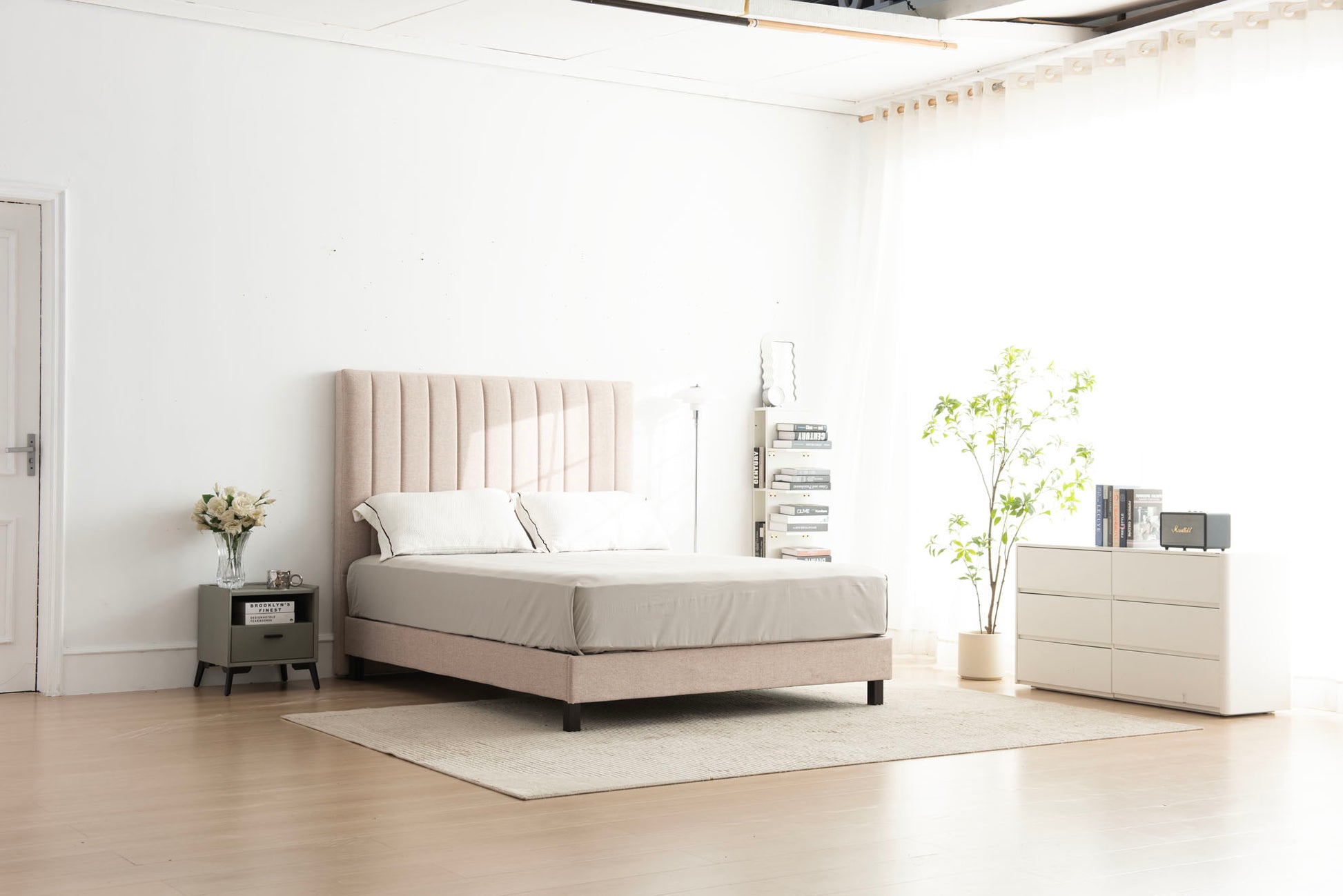 Modern bedroom setup with a bed, nightstands, and decor in a minimalistic room.