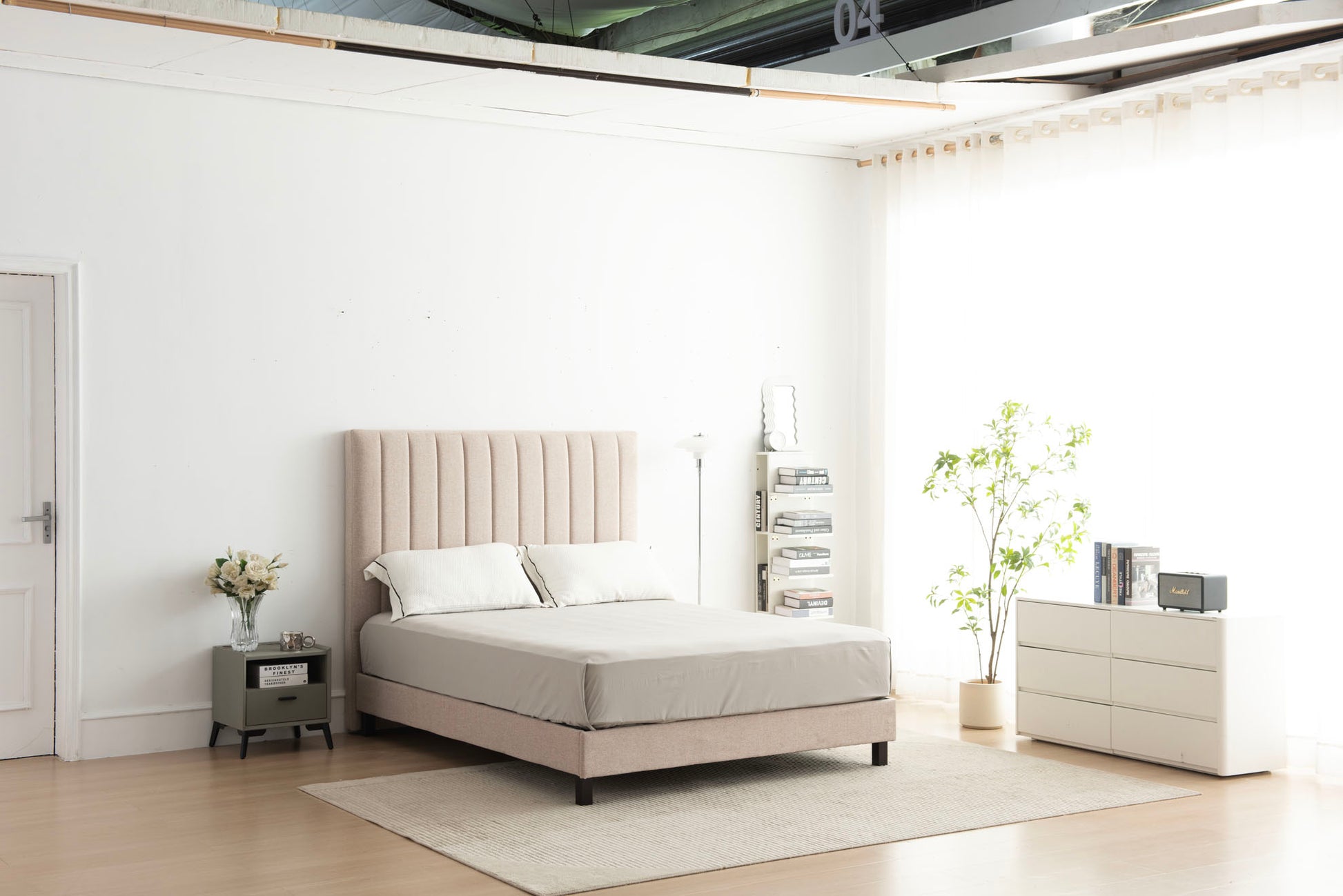 Modern bedroom with a beige bed, nightstands, and a dresser.