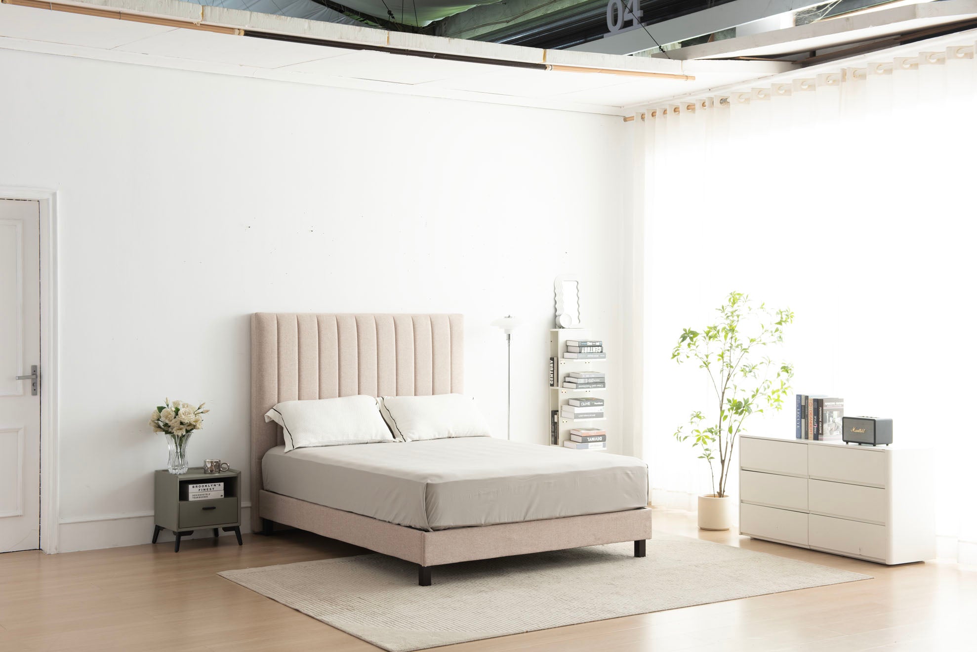 Modern bedroom with a beige bed, nightstands, and a dresser.